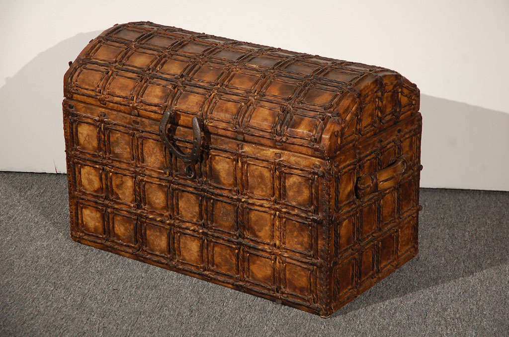 Fantastic hand made leather/rawhide dome top trunk.This very cool trunk was made in Mexico and is made from cured cow skin and rawhide.The construction is wonderful and great detail to the hardware and handmade nails.The handle to lift open the