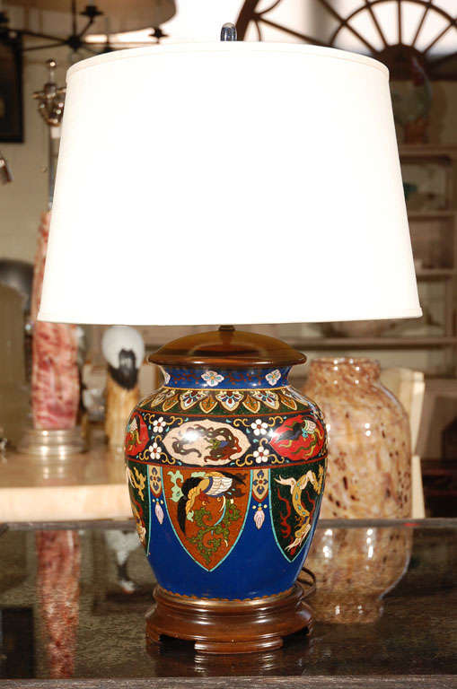 Chinese enamel and cloisonne vase mounted as a table lamp, beautiful original wood base & cap and porcelain finial. Featuring mythological dragons and birds and cobalt blue background.