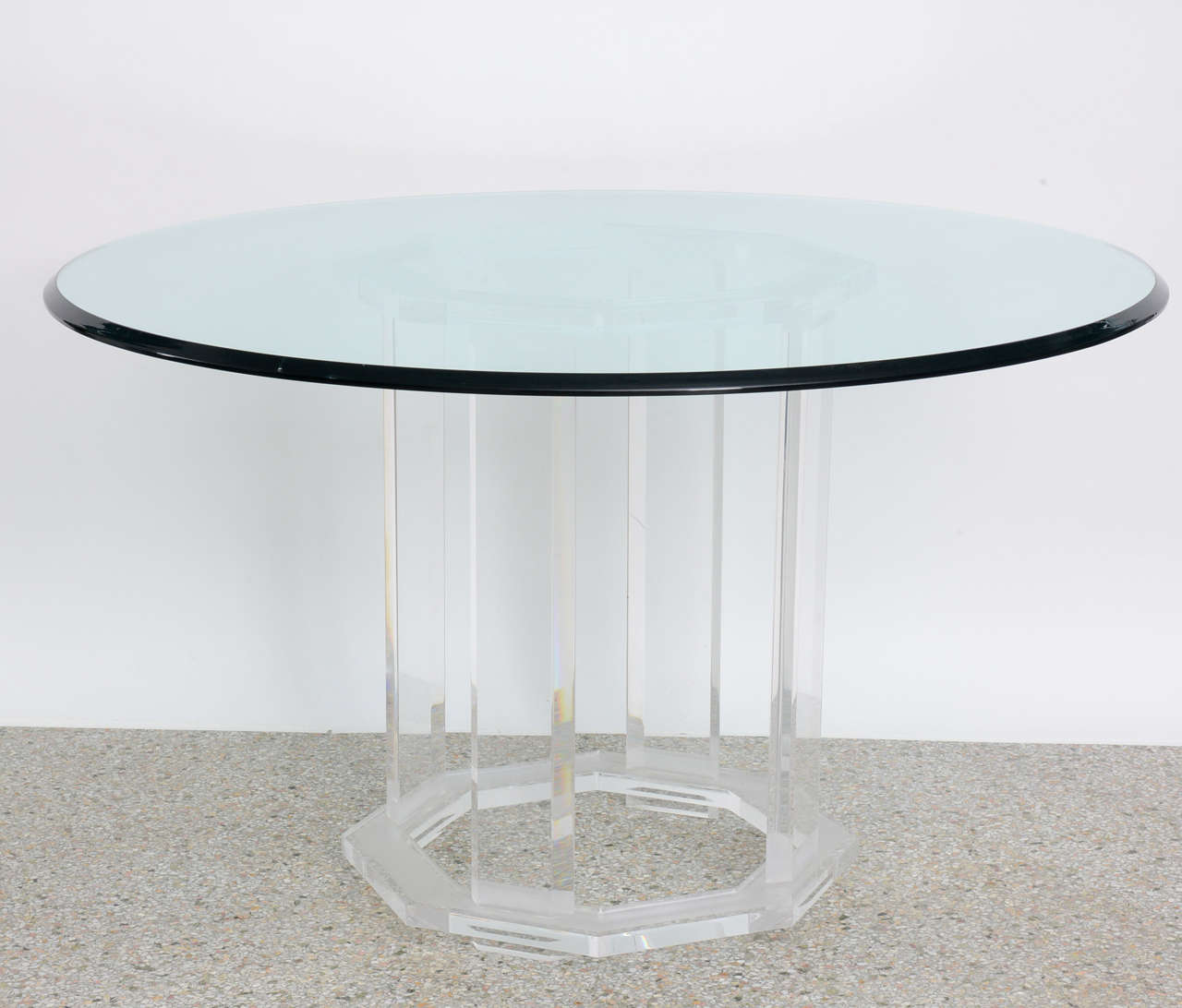 Entry or dining table featuring a round beveled glass top on a 1970's lucite base.  The top and bottom bands of lucite are frosted and the center is clear. Base alone measures 28