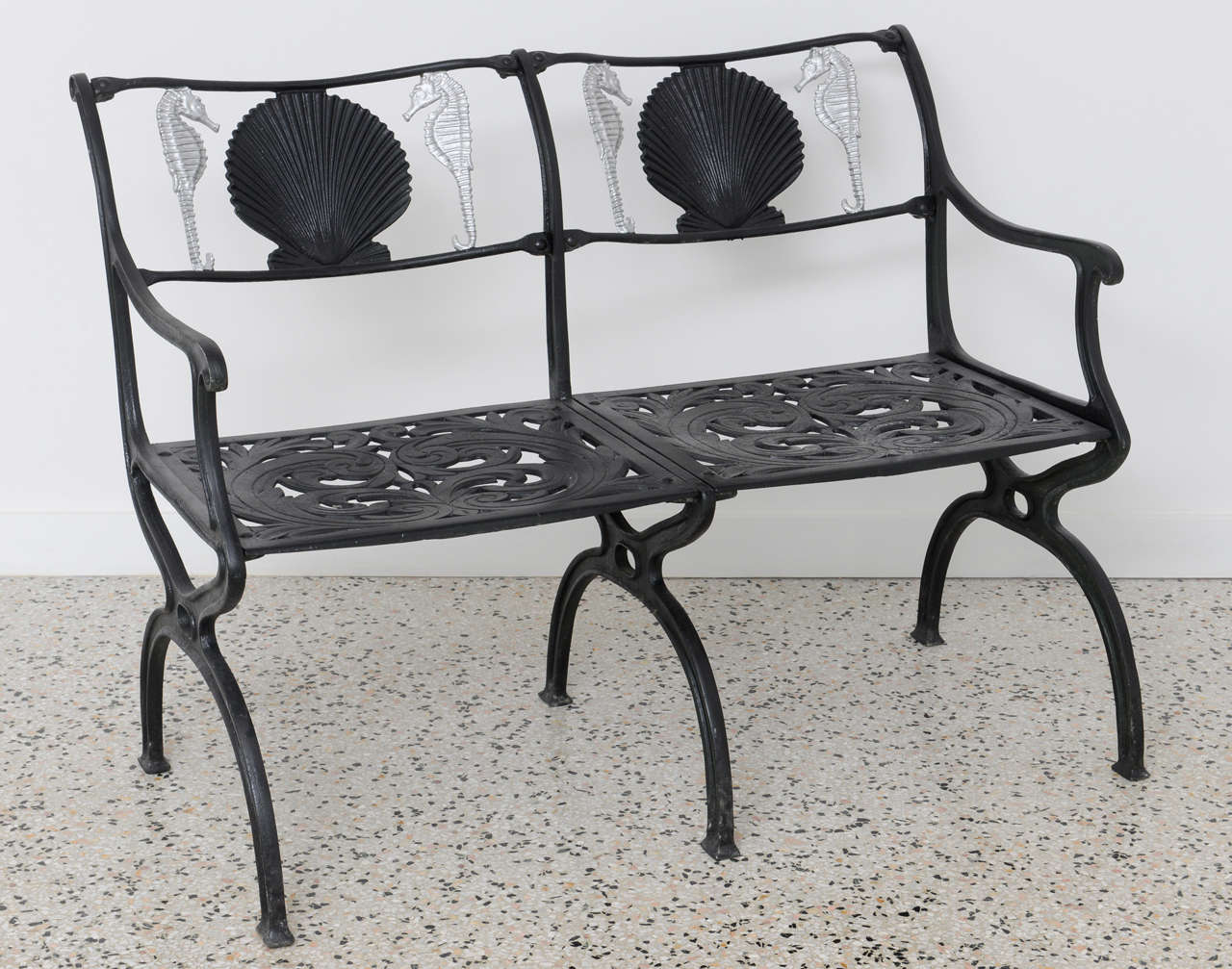 Molla cast aluminum painted black garden bench with a shell and painted silver seahorse motif. Two benches available but priced individually.  Pair of armchairs also available, contact dealer for photos and information.

Please feel free to
