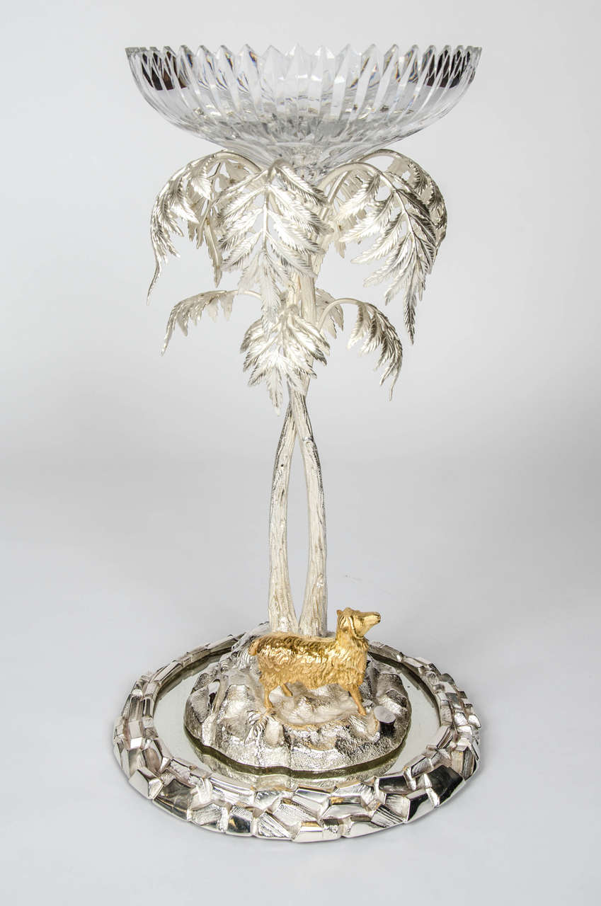 A fine and decorative centrepiece by T. Bradbury & Sons., silver plated with gilded sheep and crystal epergne dish atop, standing on a mirrored base with simulated rocky silver plated border. Dated 1888.