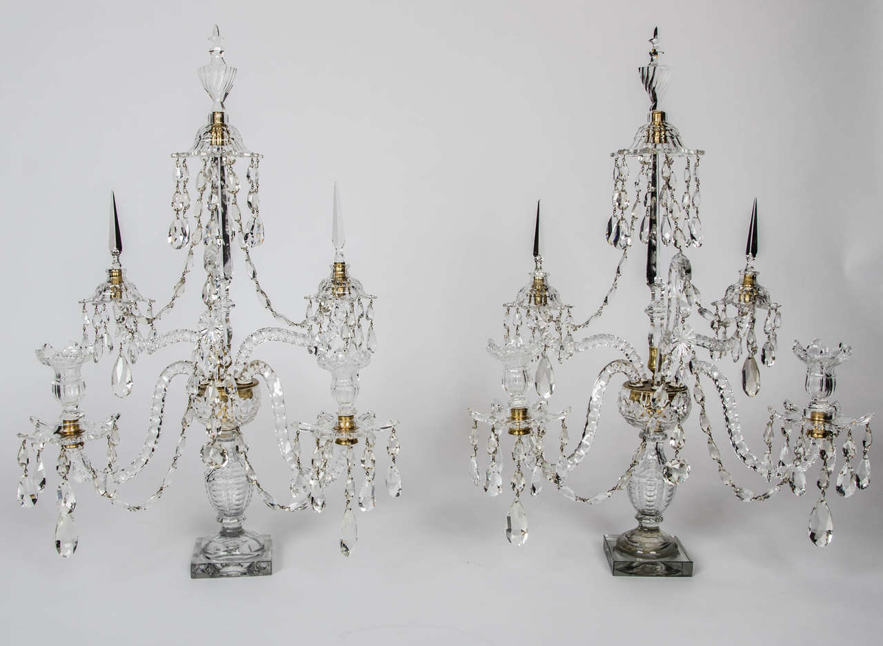 Each with two candle holders and three further S arms with swags and crystal drops the centre spire with vase shaped finial.