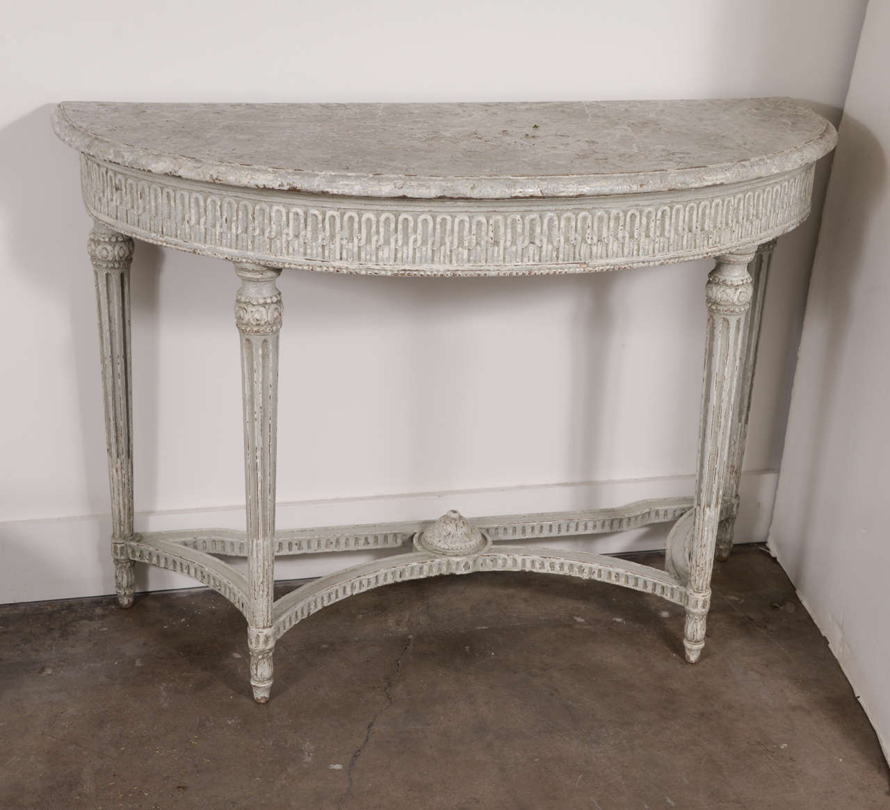 Pair of 19th century painted demilune consoles with beautiful carving throughout. Top has a subtle faux marble finishing. Paint is more recent.