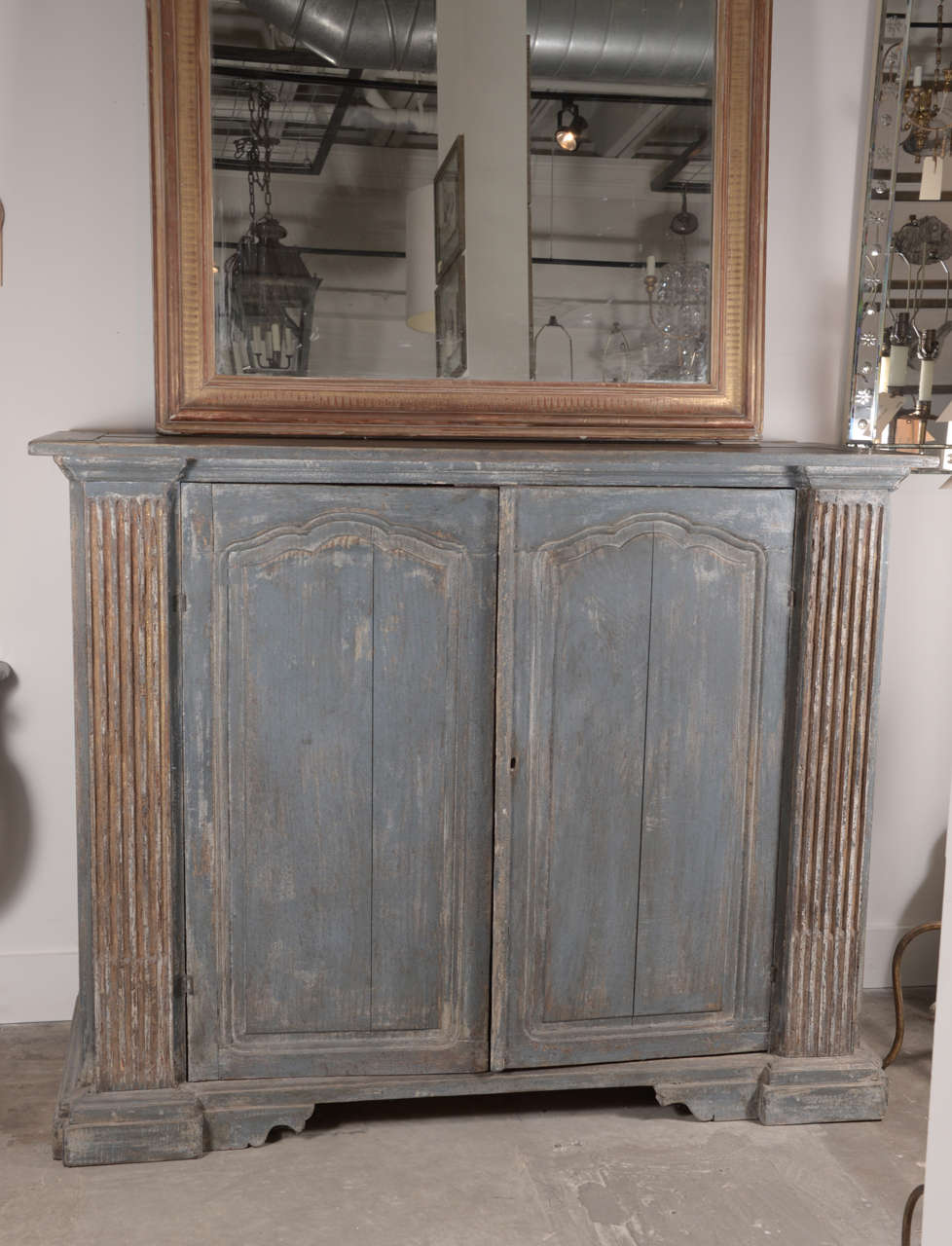 An Italian Neo-classical-style painted buffet with traces of gilt along the reeded columns flanking the facade of the piece.  Doors are early Louis XV 