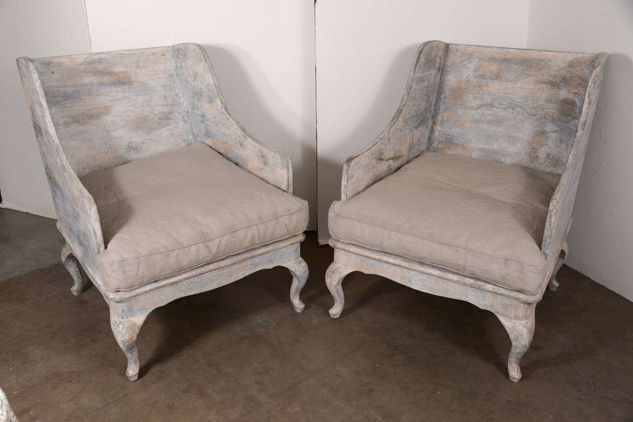 Pair of decorative Swedish style custom carved chairs found in provence. Carved to resemble 18th century style chairs. Beautiful painted blue-gray-beige finish throughout. Comes with a seat cushion.