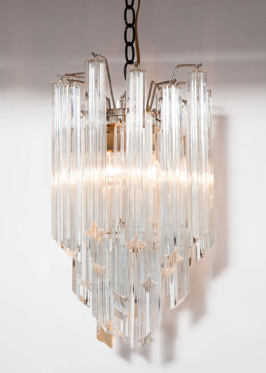 An elegant, small-scale chandelier with chrome frame and crystal drops by Camer.  Italy, circa 1960. 
Perfectly sized for a hallway or bathroom.
Newly polished and rewired for U.S.; takes three candelabra base bulbs, 60 watts max each.
Measures 18