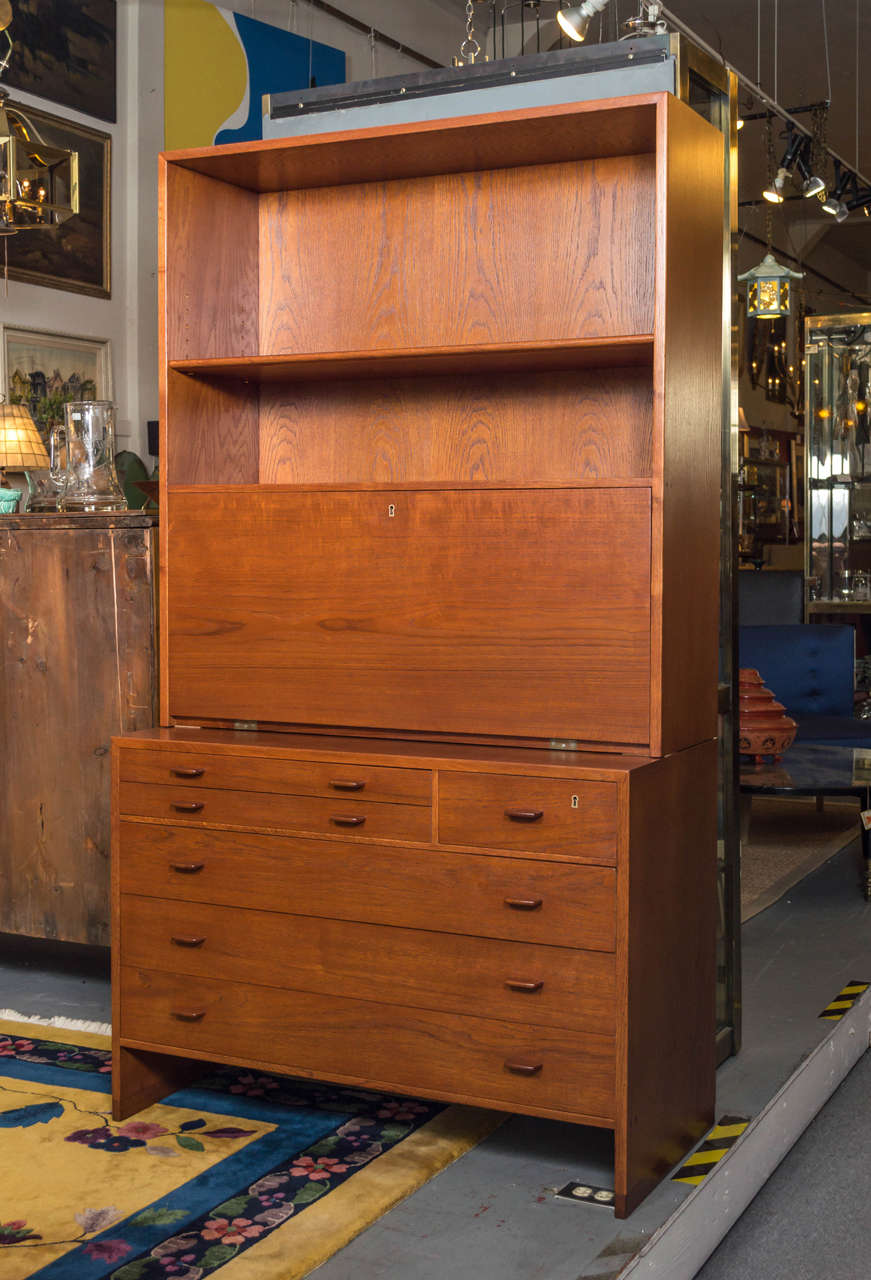 Dieses kompakte Teakholzmöbel bietet eine Menge Arbeits- und Stauraum. Entwurf von Hans Wegner:: hergestellt von RY Mobler. Die untere Hälfte hat drei große Schubladen:: darüber befinden sich zwei kleinere:: die mit grünem Filz ausgekleidet sind.