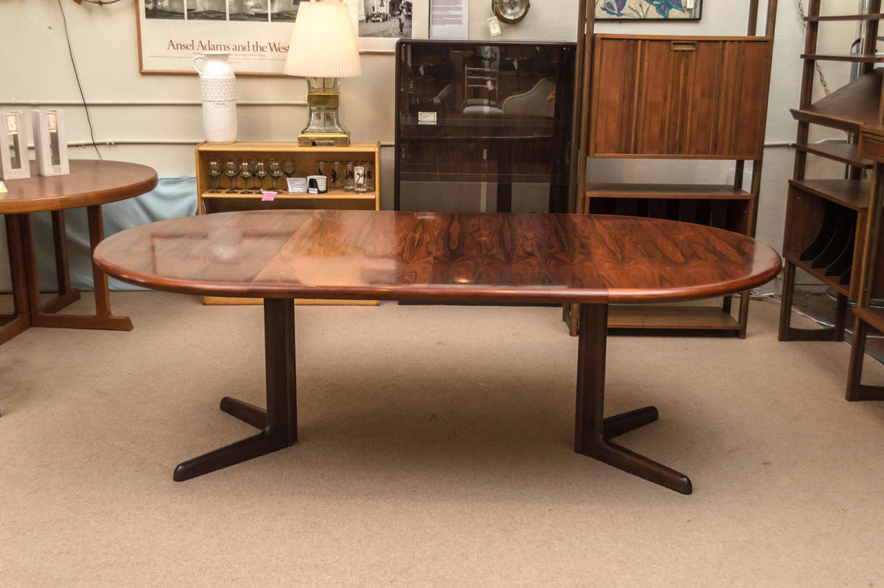 circa 1970s Danish modern dining table with two leaves, made by Gudme. Table has some nice looking grains in the wood. Measurements below are with leaves in, each leaf is 19.25in wide.
