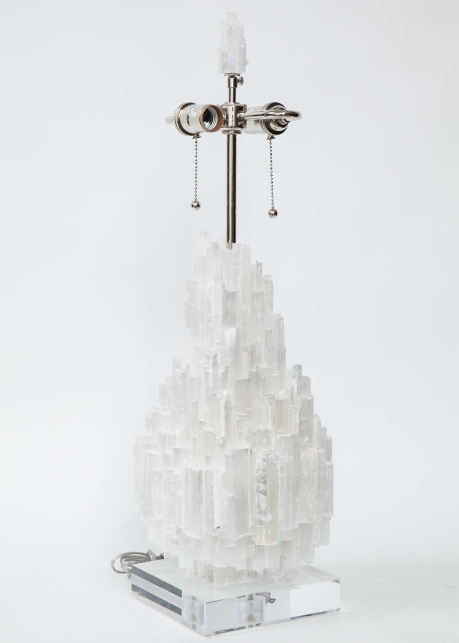 Pair of custom made vertically stacked Selenite Crystal encrusted lamps on Lucite bases. Lamps feature double pull chain sockets in polished nickel.