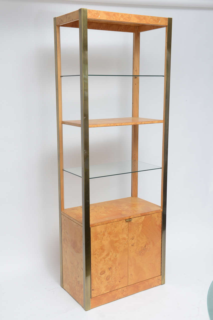 Great pair of matched etageres in burled olive wood with brass framing. One centered wood shelf and two glass shelves.