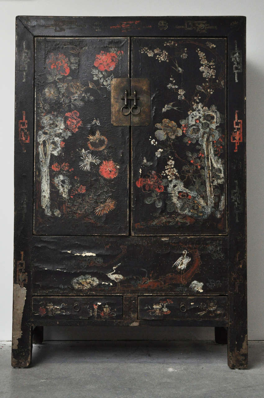 20th century painted Chinese black lacquer cabinet. This 20th century cabinet was repainted in the original style. The interior has a shelf and two drawers. From Northern China.

Dimensions: 50