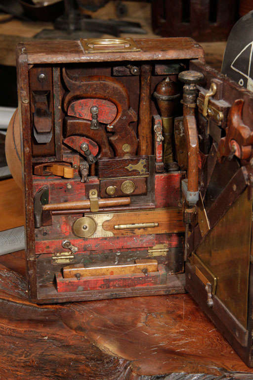 This amazing toolbox was obviously custom fitted for a specific trade. A carpenter or wood worker would bring this to there specific job .it has the flavor of a Joseph Cornell shadowbox