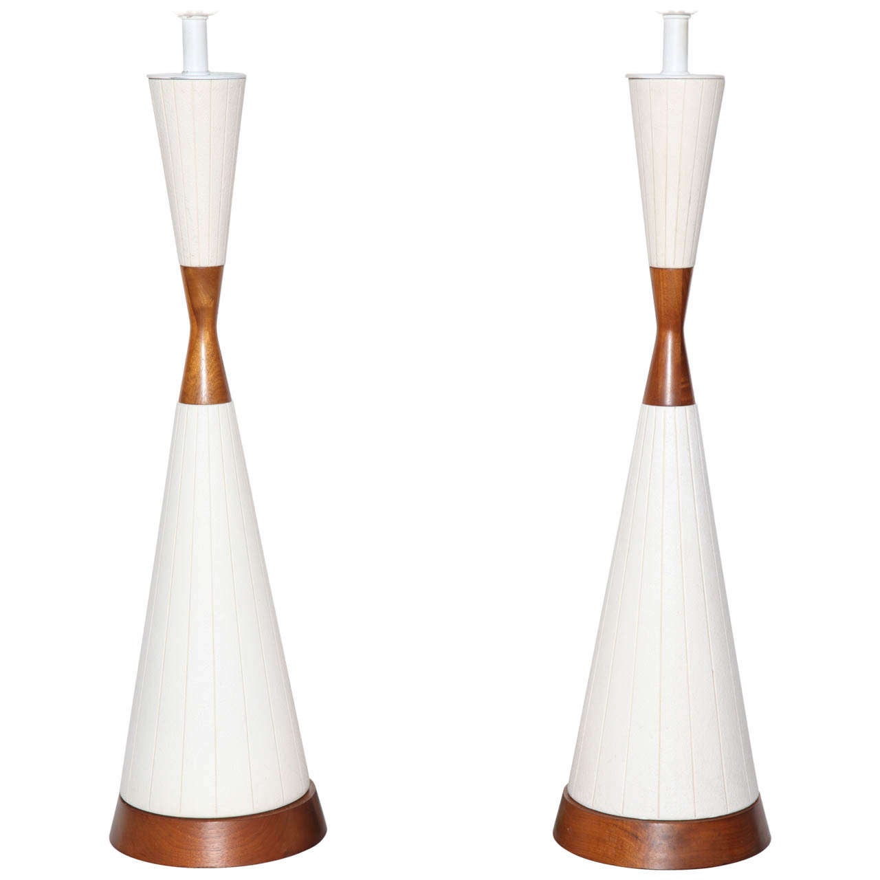 Pair of American Mid-Century Modern White Linear Incised Ceramic & Walnut Table Lamps. In the manner of Michael Lax.  Featuring an hourglass form in Off-White Ceramic with cut vertical details, Walnut waist and (7D) tapered base. With original