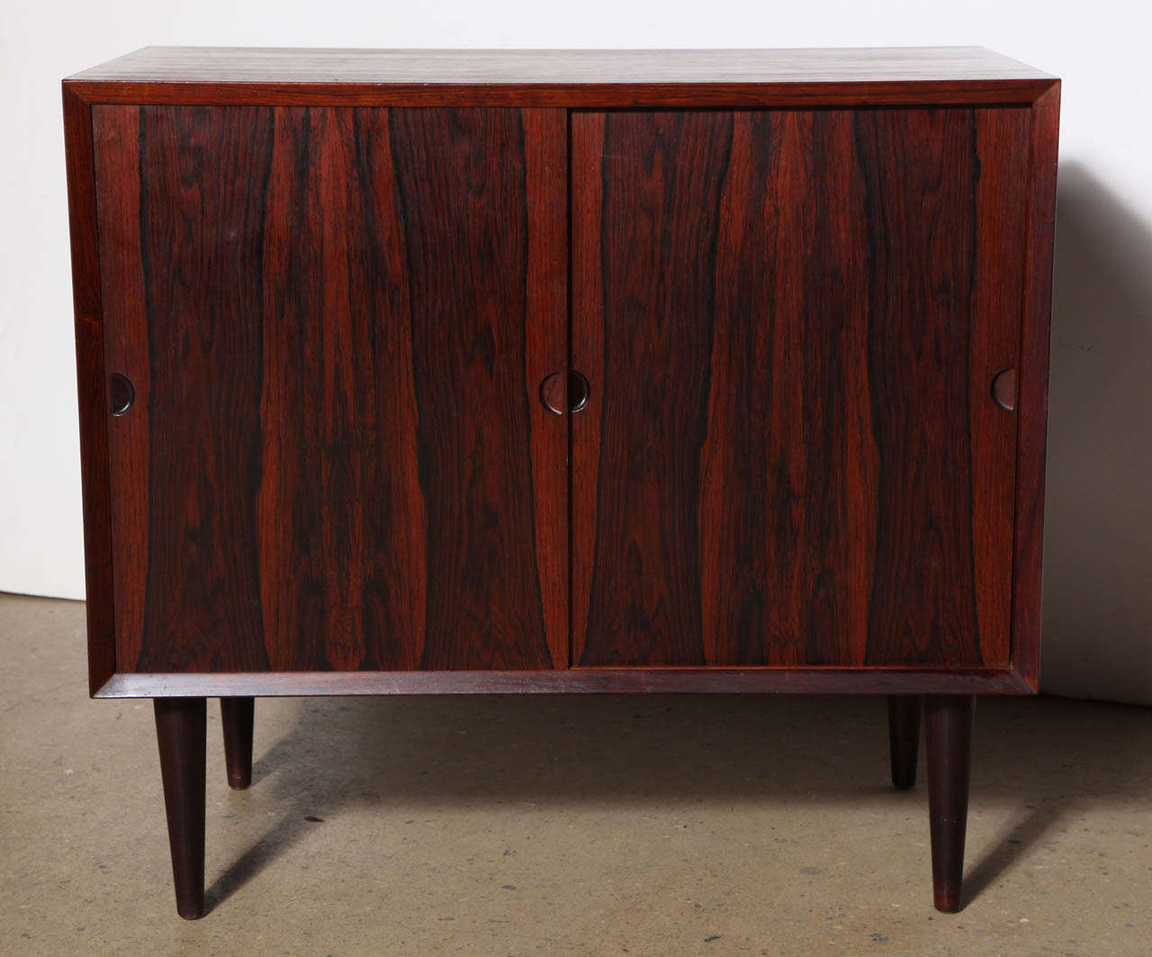 small Poul Cadovius Mid Century Modern Sideboard with 2 sliding doors, 
2 upper drawers with dovetail joints, round finger pull detail and adjustable shelf. From floating 