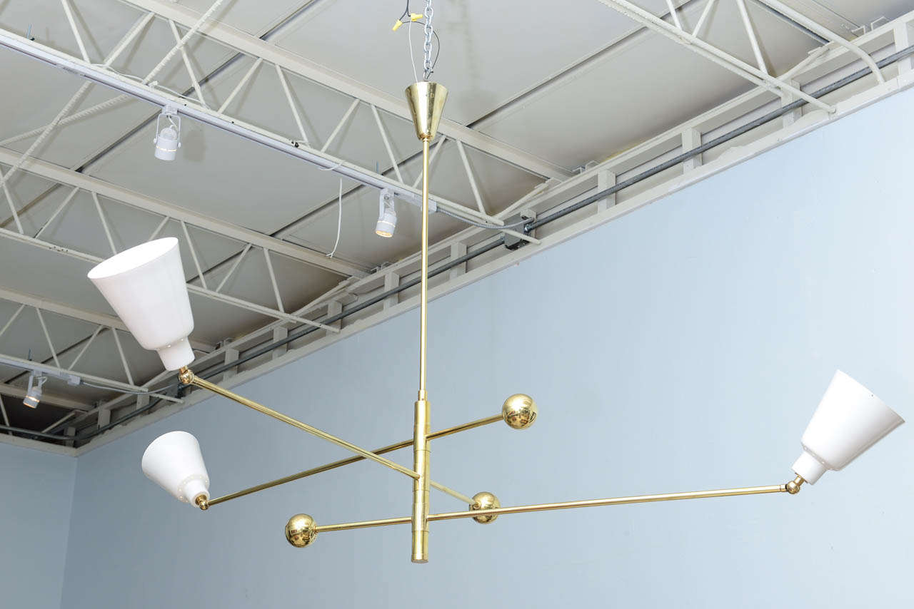 For Arredoluce, the three adjustable cone lights on brass rods with counterbalance spheres all adjustable on a central cylinder,
Provenanve- Phillips, London also same model with different color cones, Wright, Chicago.