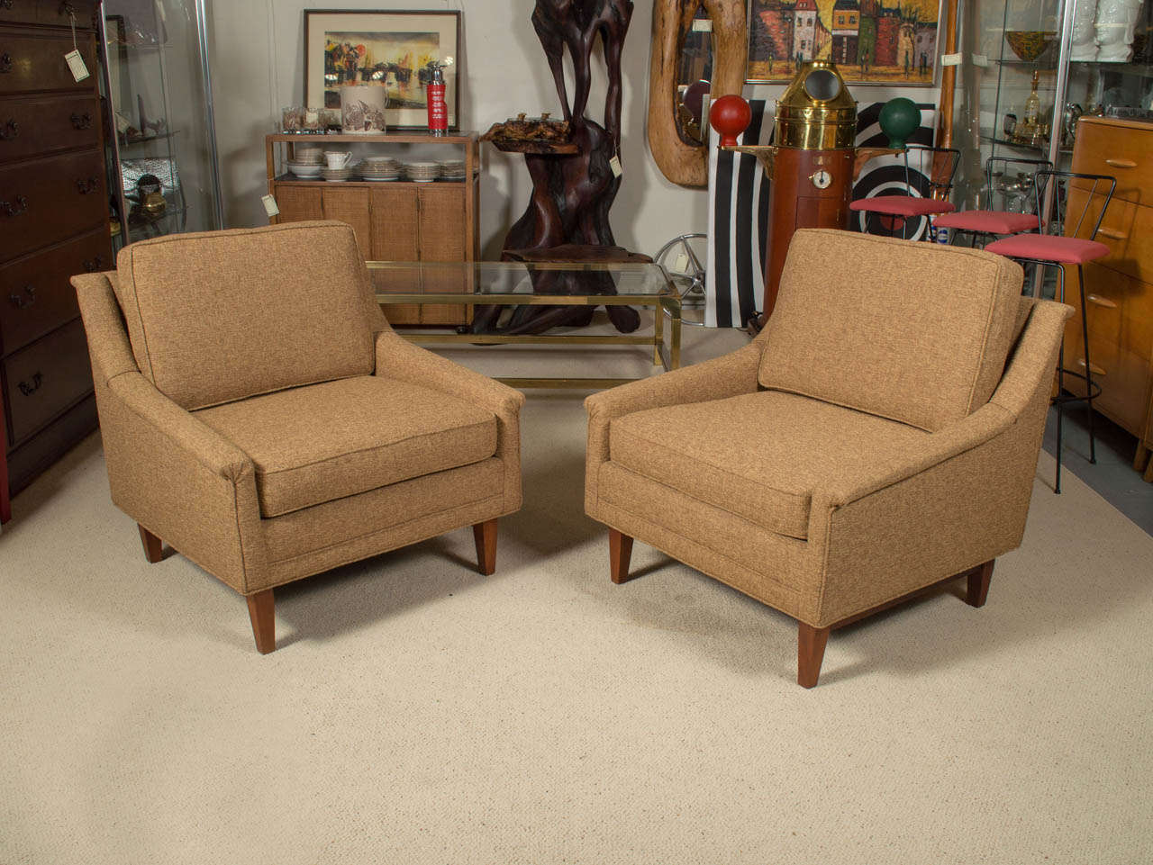 A very handsome pair of Mid-Century upholstered lounge or club chairs with walnut legs.

Sweeping winglet arms recall Folk Ohlsson’s signature designs for DUX. Classic 1950s American body has comfortable proportions, broad sides and back, and