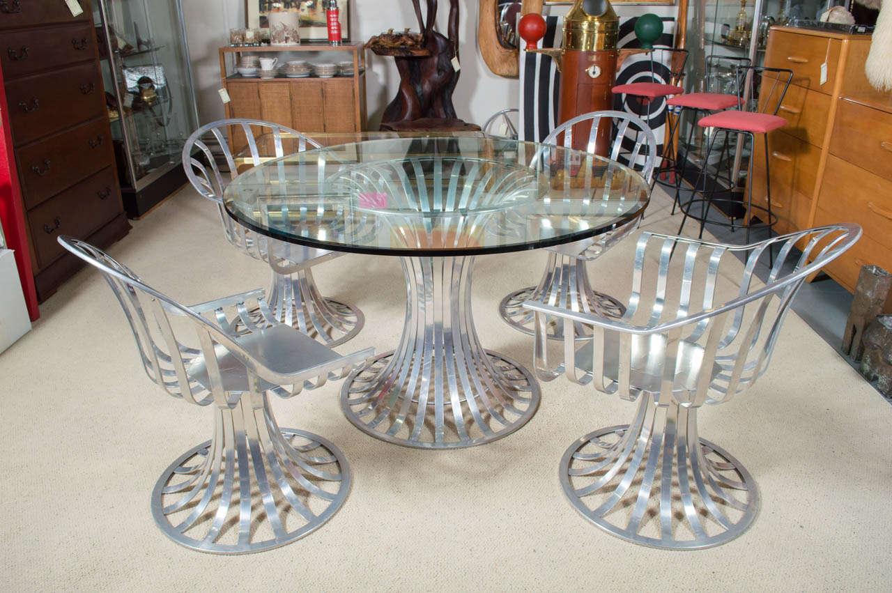 A Russell Woodard design for Lee L Woodard Sons Inc. Circa early 1960's welded Aluminum slat, with and hour glass shape bases. This design was only produced for a short time, because of the cost to make it. This set was kept indoors, in a covered