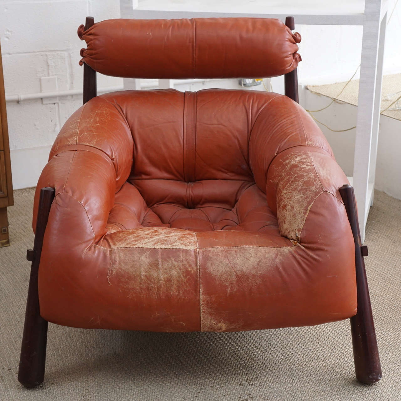 Here is a great Percival Lafer club chair in a slightly distressed leather.
The legs are done in a dark rosewood finish and the seating is plush.