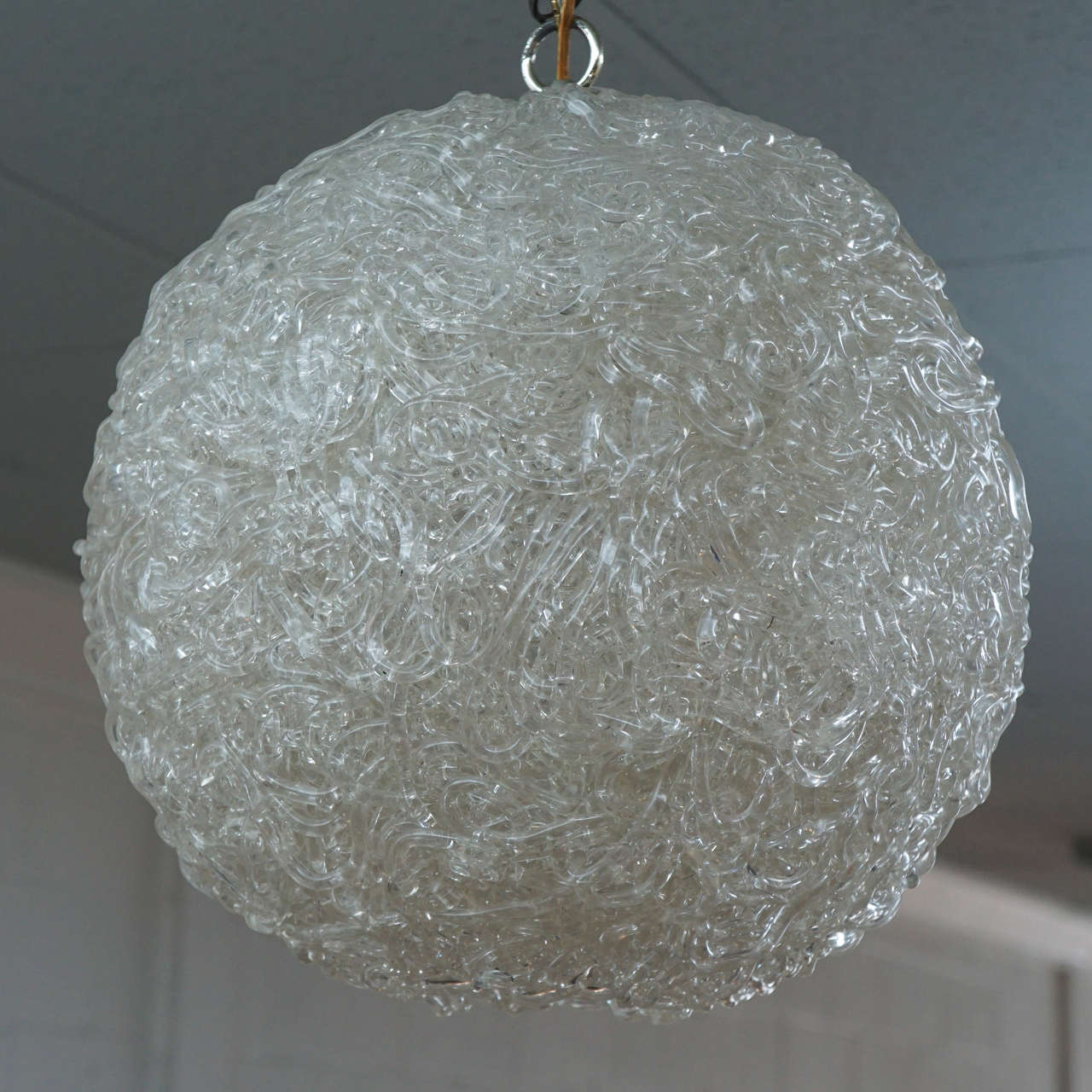 Here is a great spaghetti resin sphere light fixture from the 1960's.
The globe has an opening underneath and is wired with a plug in.