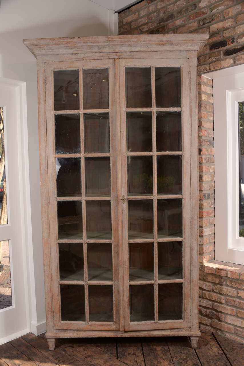 Fabulous Swedish cabinet with original glass.  Beautiful old painted finish, most likely original to the piece. Early 19th century.  A stunning piece.  Inside has been painted later.