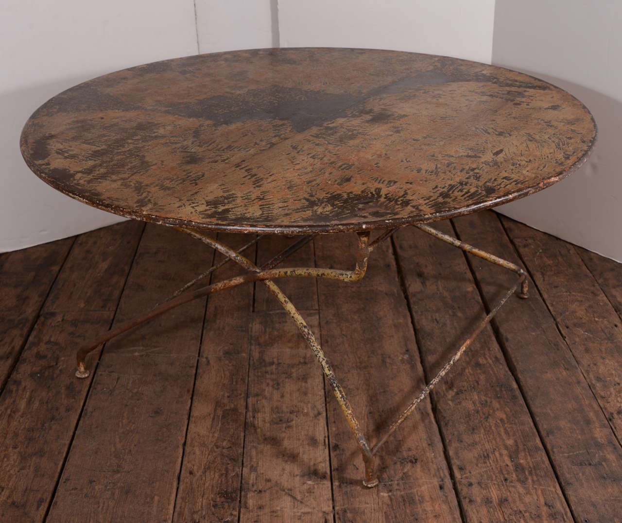 Fabulous round French iron table from the 19th century, great patina and form. Top is in perfect condition for everyday use. Folds easily for transportation.