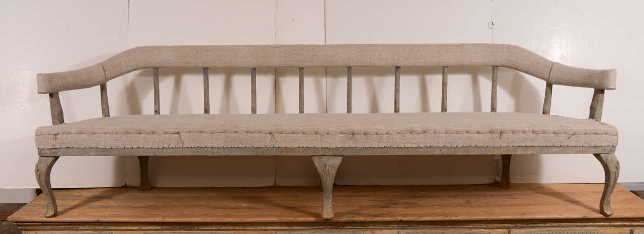 Very large and unusual Swedish Rococo bench, scraped to the original paint. Upholstered in a vintage linen.  A stunning piece!