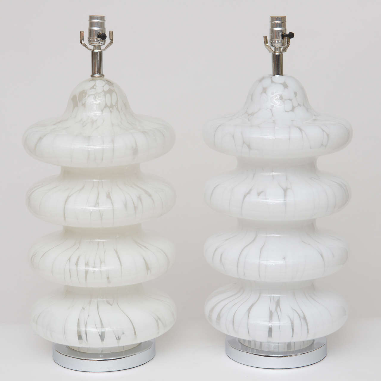 Tall, four-tiered table lamps with tortoise-effect Murano glass in clear and white. Nickel hardware, new wiring. Height measurement below is to top of socket.