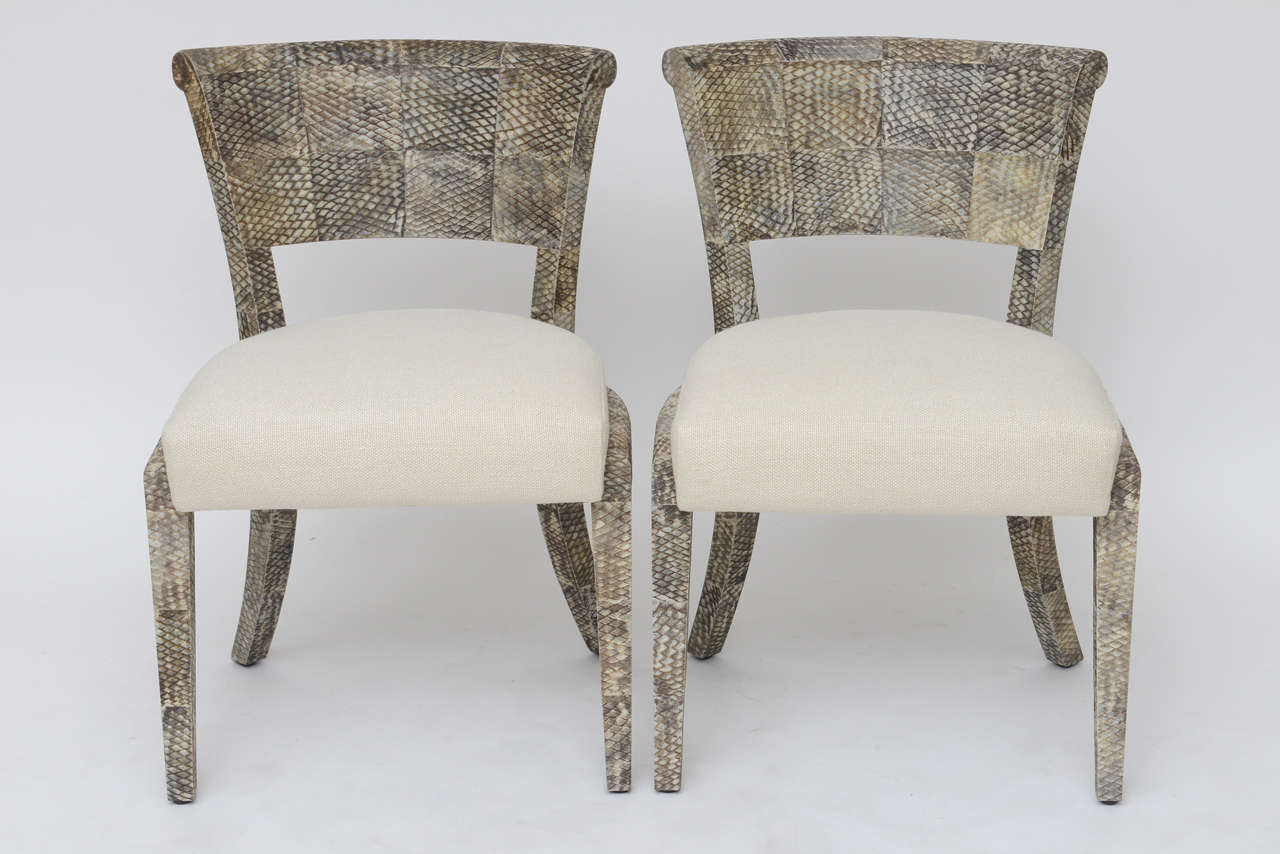 Similar in look to snakeskin, but far more durable, we love the texture and color of these luxe chairs with frames covered in natural fish skin with a smooth matte finish. Upholstered in a thick cream Belgian linen. Priced and sold individually.