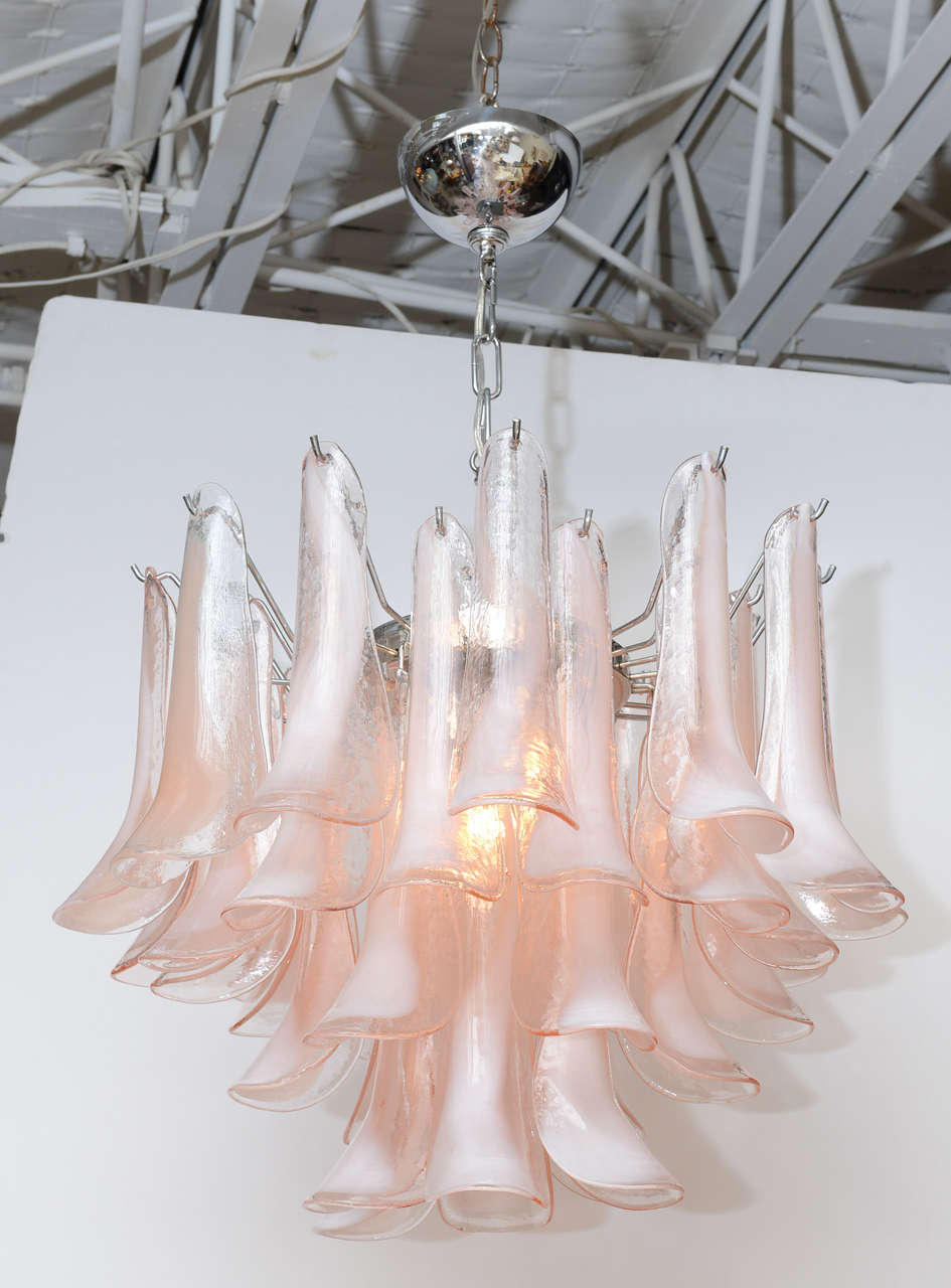 1970's chandelier by Mazzega with four staggered tiers of handblown Murano glass petals in a flattering, soft pink (not peach). Chrome frame.
