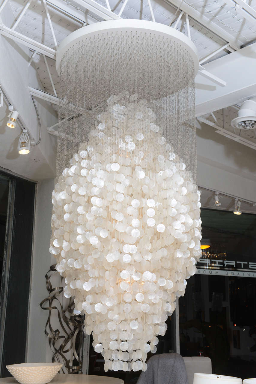 A 1964 design - and the largest of Panton's Fun series - this stunning chandelier shimmers with strand after strand of mother-of-pearl capiz shells. Three sockets (100W maximum) create a captivating glow from within.