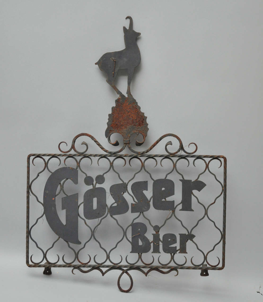 Austrian wrought iron Gösser beer sign from the turn of the 20th century. Rectangular shaped frame with Gösser Bier logo amidst scrolled background, surmounted by a graceful stylized stag ornament. Gösser Bier is not only one of the best brands of