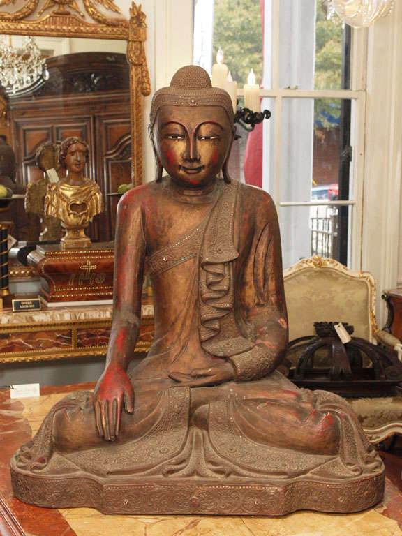 Exceptionally Large Thai Buddah with original gilt finish and red bole coming through. Has small metal stud decoration around fabric edges.