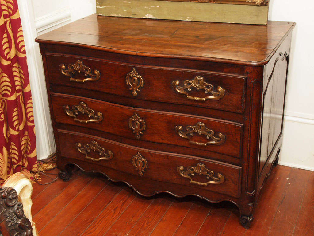 18th century walnut commode from Bordeaux region of France. The pulls and escutcheons are original. Great paneled sides.