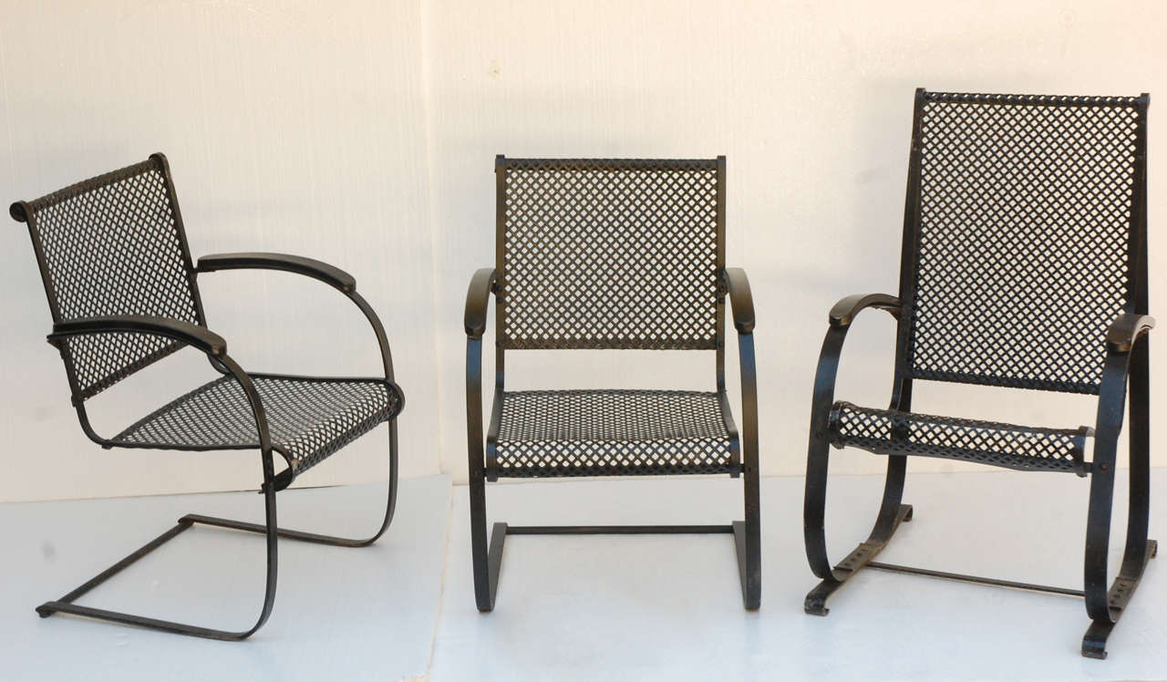 Three woven iron bounce chairs from 1940. Made of spring steel frame with steel mesh seats and backs Excellent condition and minimal wear to each chair. Smaller two chairs measure 36 high x 23 1/4 wide x 25 deep. Larger chair measures 40