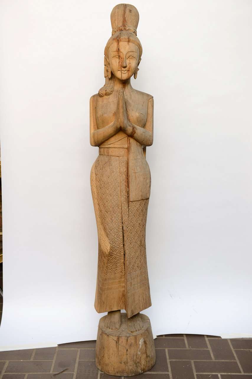 Large quan yin Buddha statue made of carved wood in the primitive 
Look .very impressive in size ,the beautiful face has the impression 
Of time a split ,which in my opinion just add her.