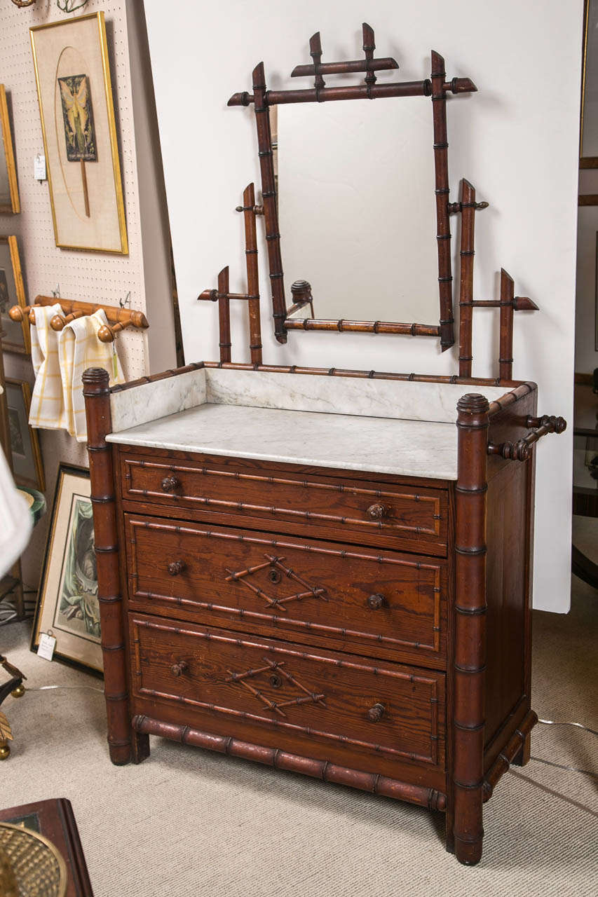 English Faux Bamboo Washstand with Swivel Mirror and Marble Top with three drawers.