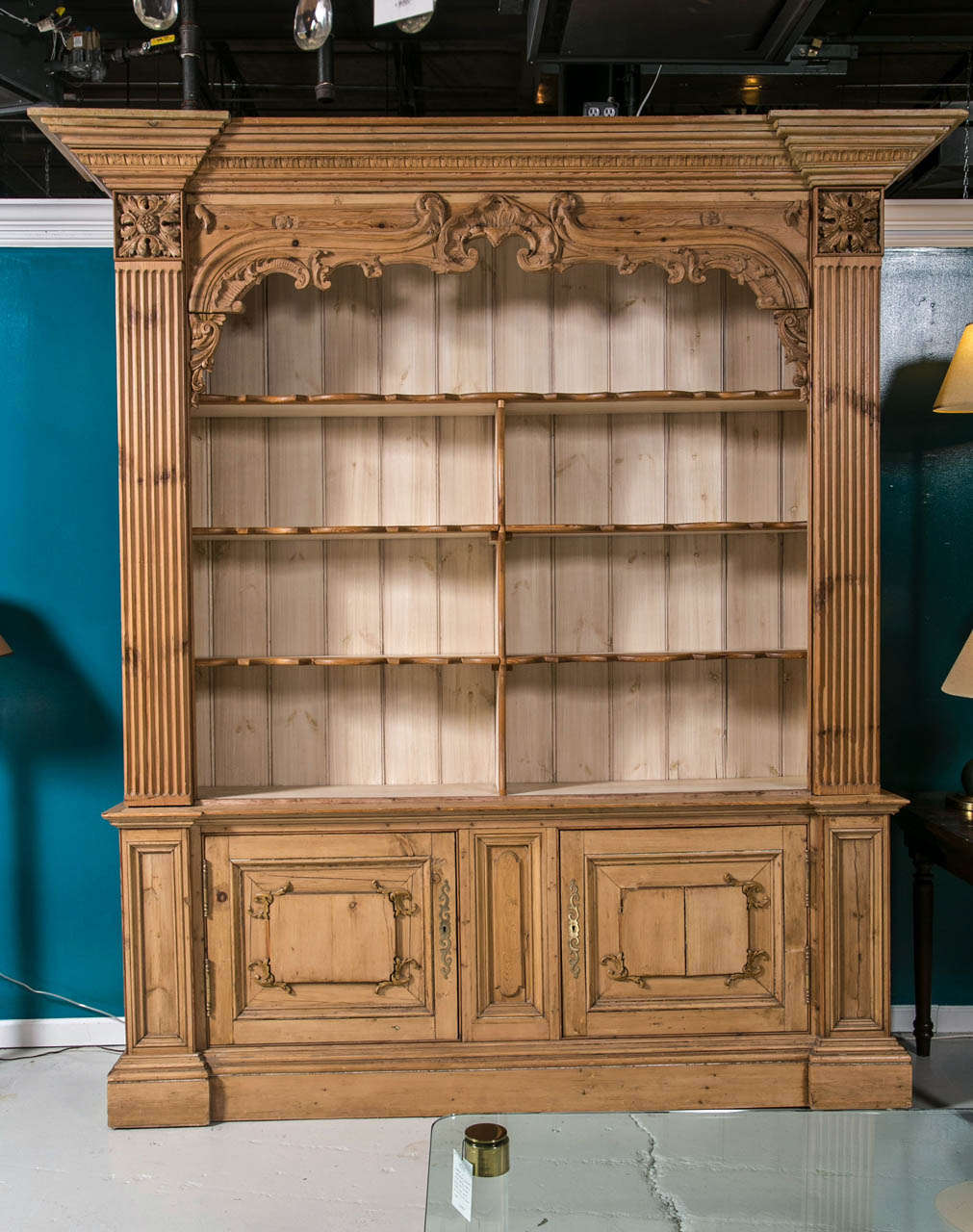 Carved Pine Open Cabinet over Two Paneled Cupboard with lock and original brass key.  Stong architectural elements, carved gothic style upper frame under cornice heading.  A handsome quiet piece for display of books, pottery, linens or collectables