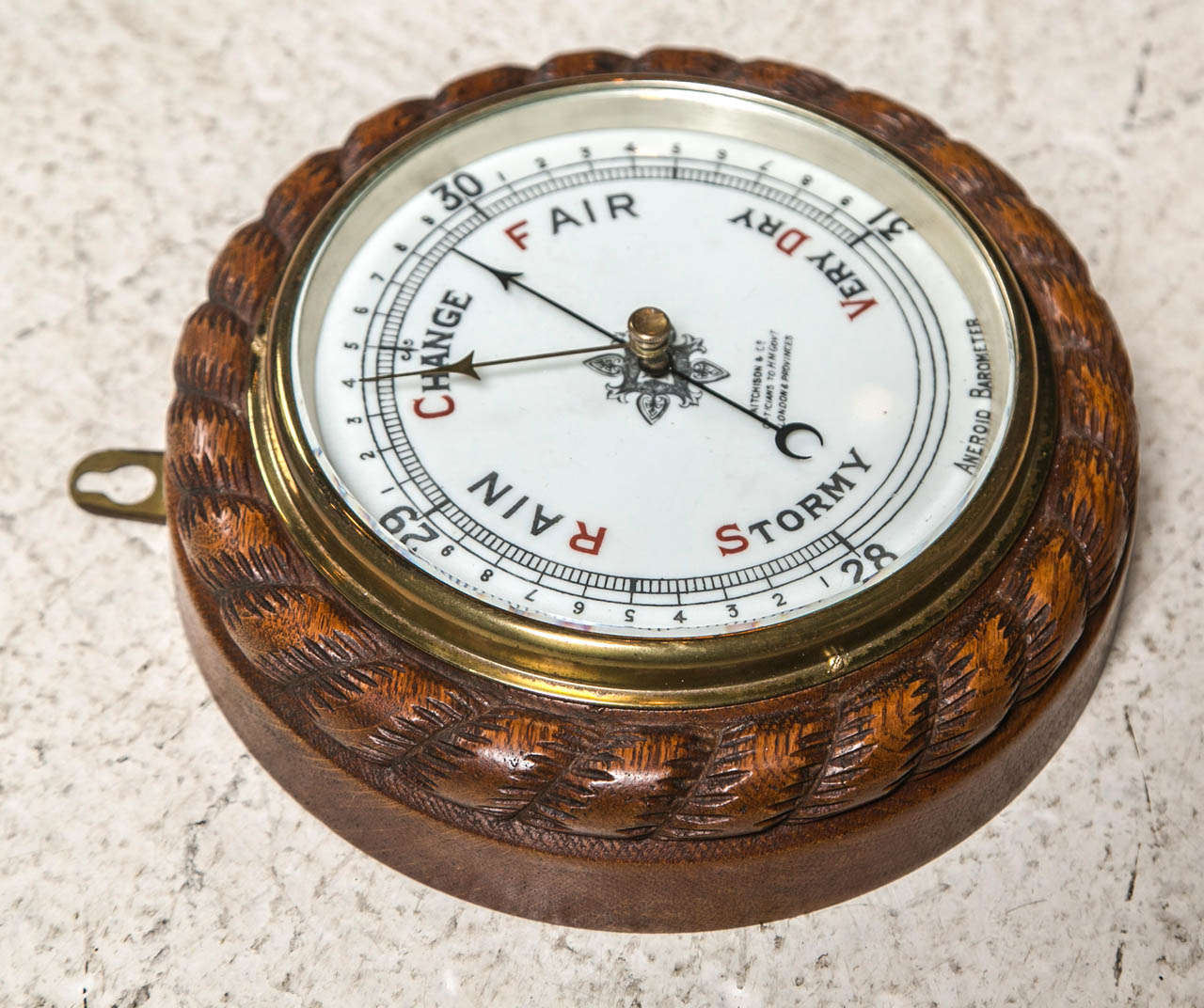 Carved Oak Rope Cased Aneroid Barometer C 1890. White porcelain dial with red capitals and signed 'Ritcheison & Co Optitians to HM Boennment London & Provinces'.  This Barometer has 4