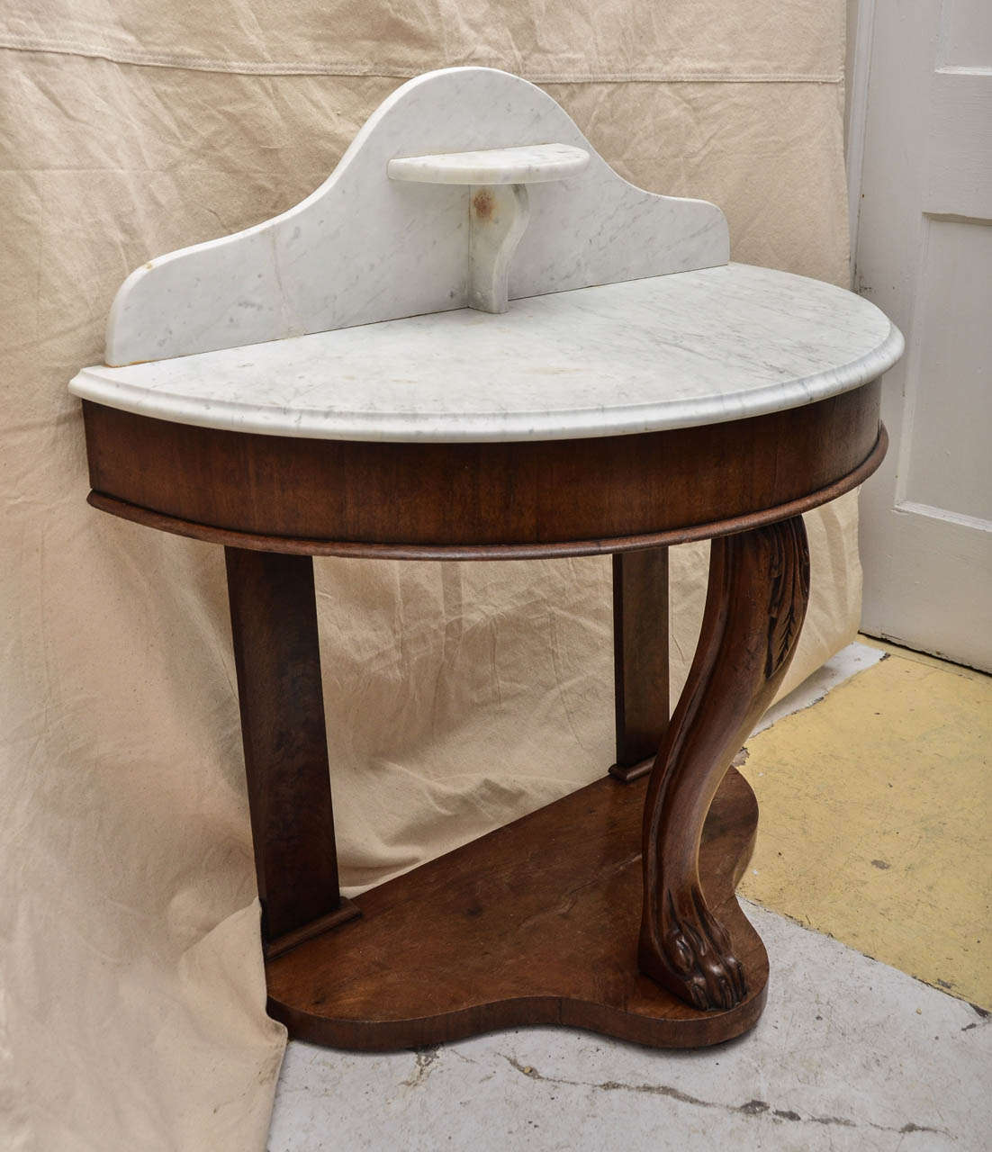 English Wm. 1VTh Demi Lune Marble Top Washstand Has A Arch Shaped Back With Half Round Shelf In The Center Of the Back. The Base Is Shaped To Echo The Backslash Shape. The Back Two Legs Are Flat With Three Quarter Round Molding Surrounds. The Front