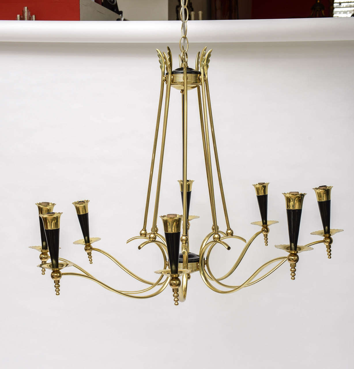 Mid-Century Modern Italian Brass Chandelier with Eight Arms.
Eight socket holders in brass and aluminum cones painted in black lacquer.
The chandelier is in perfect working condition and it takes 8 light bulbs with max. 25 watts.
Can hold little
