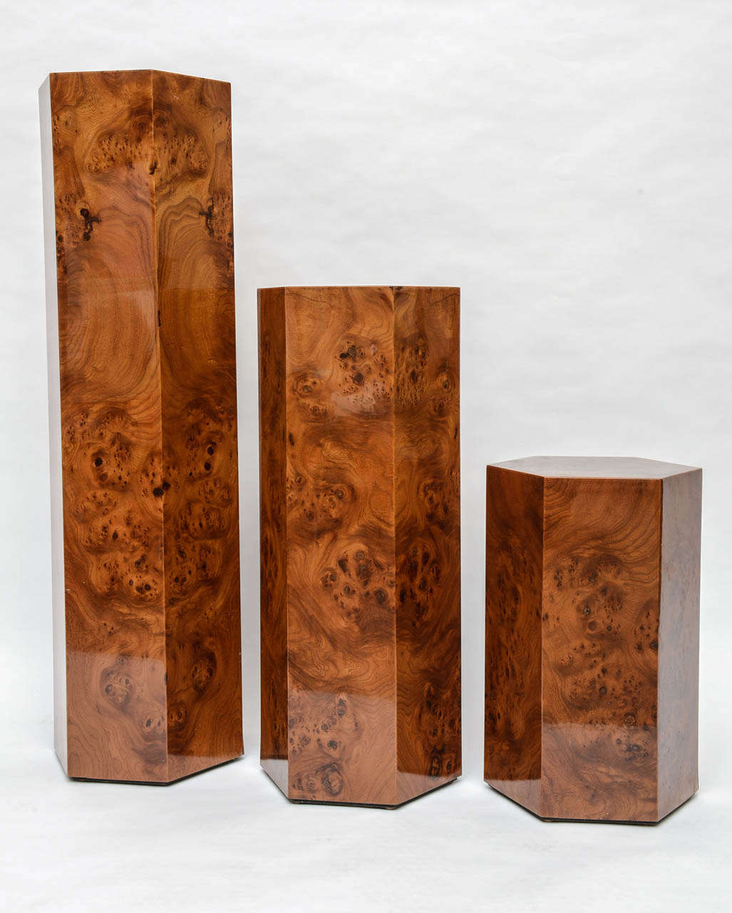 Expertly made pedestals in burl wood. Continuous wood pattern on all three pedestals.
Measures: Heights are 18.25 inches, 28.25 inches and 40.25 inches.