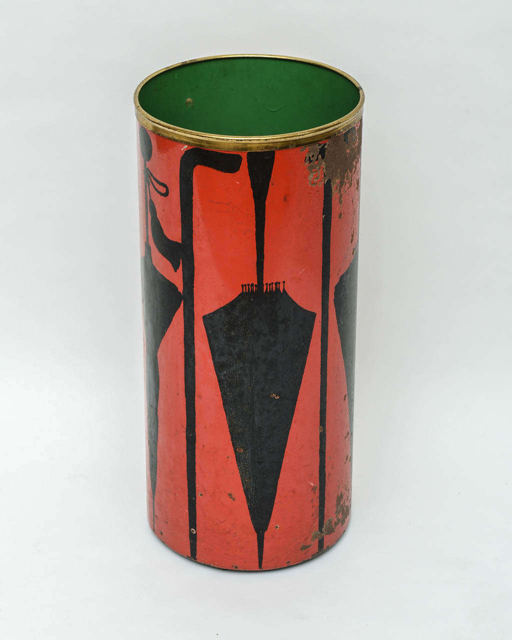 Distressed umbrella stand in the style of Fornasetti by Felice Galbiati Arte of Milan Italy. Heavy metal canister with black depictions of walking canes and umbrellas on a red background and topped of with a brass crown.