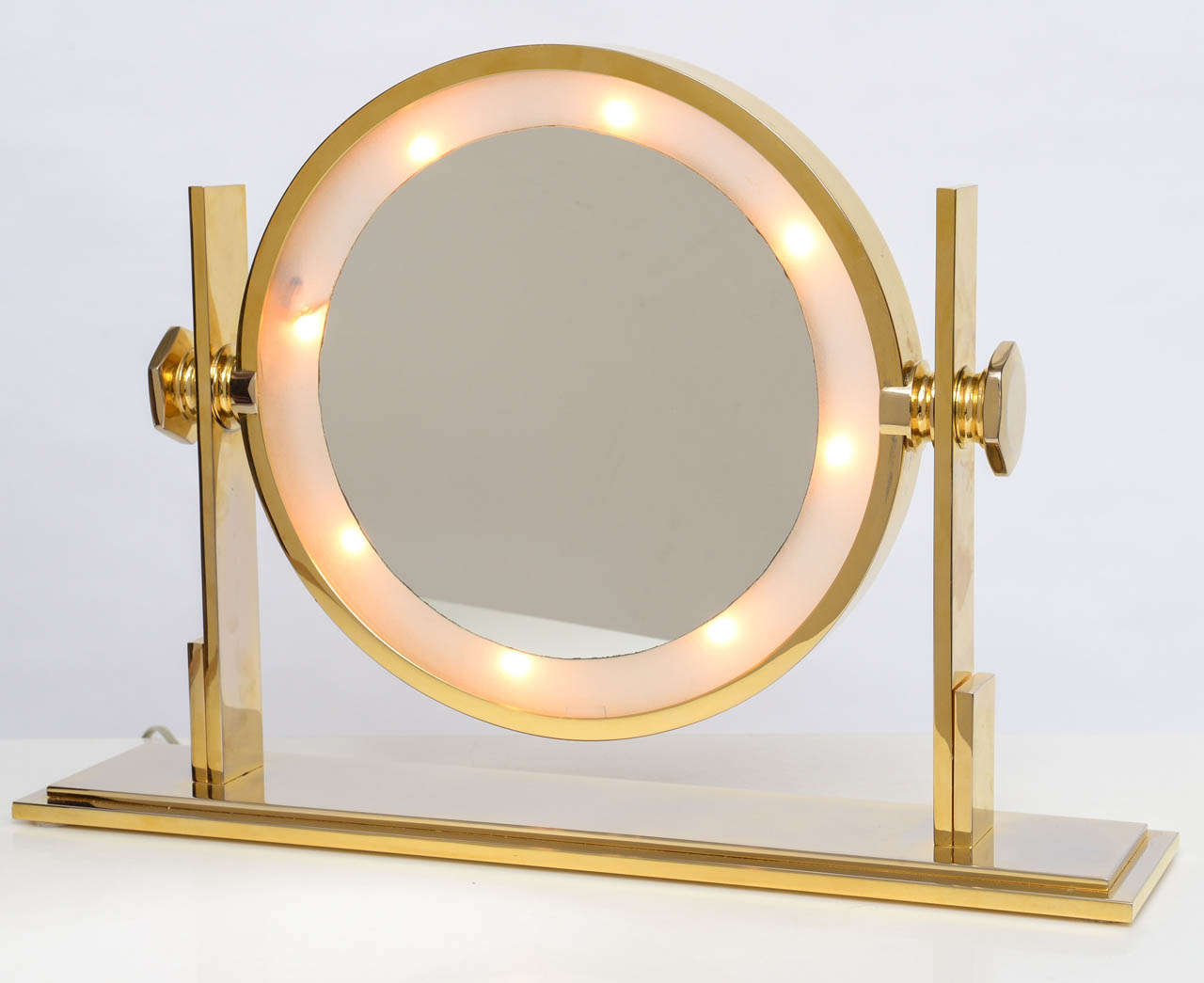 Uber-stylish, Karl Springer table top vanity mirror has gold-plated steel frame and lighted mirror with magnifying side on the verso.