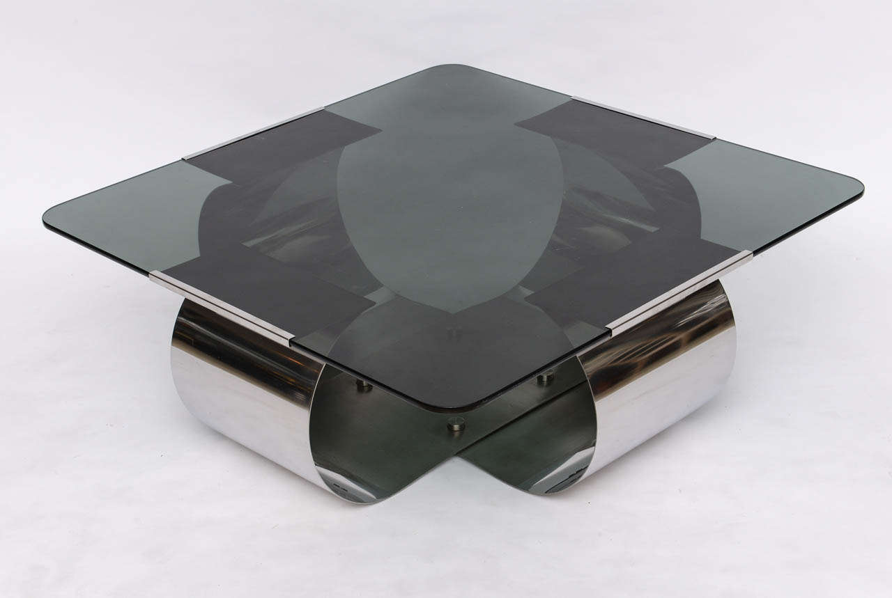 Sexy polished steel coffee table by Francois Monnet, with lightly smoked grey glass top.