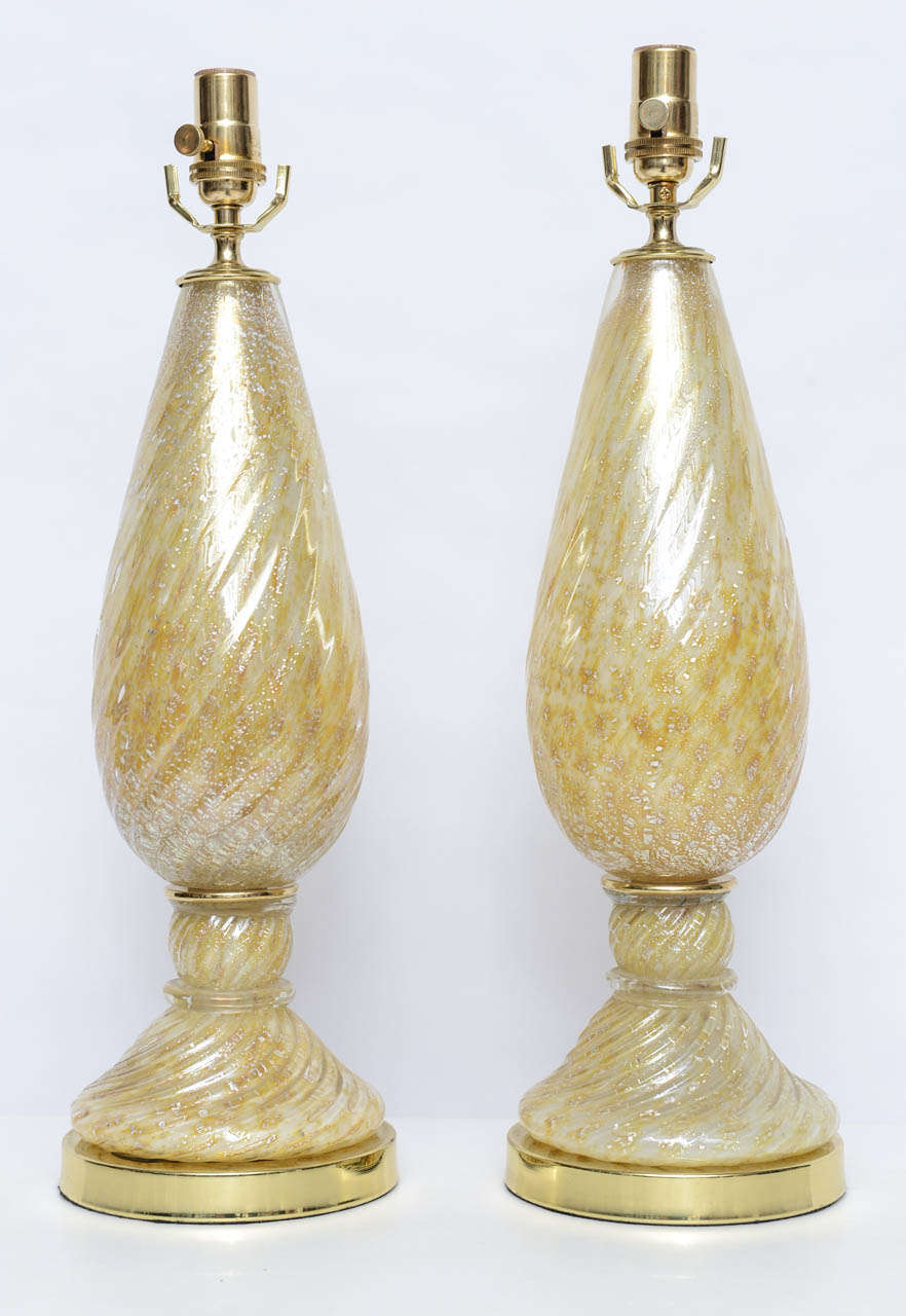 Very pretty pair of Barovier and Toso lamps of handblown Murano glass in shades from white to yellow to amber, with silver leaf inclusions. Solid brass bases and hardware. Professionally polished and re-wired with woven cord.