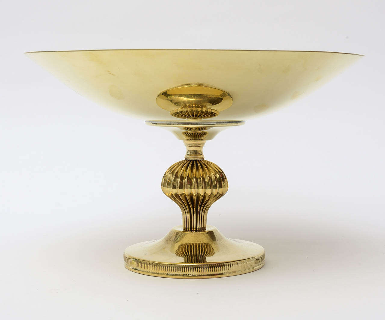 Great polished brass Pedestal bowl in the style of Tommi Parzinger.
it has a rimmed bottom with lines and a sculptural form in the middle.
The weight is on the lighter side...

NOTE: THIS WILL BE ON THE SATURDAY SALE FOR 1 WEEK ONLY  THRU MAY