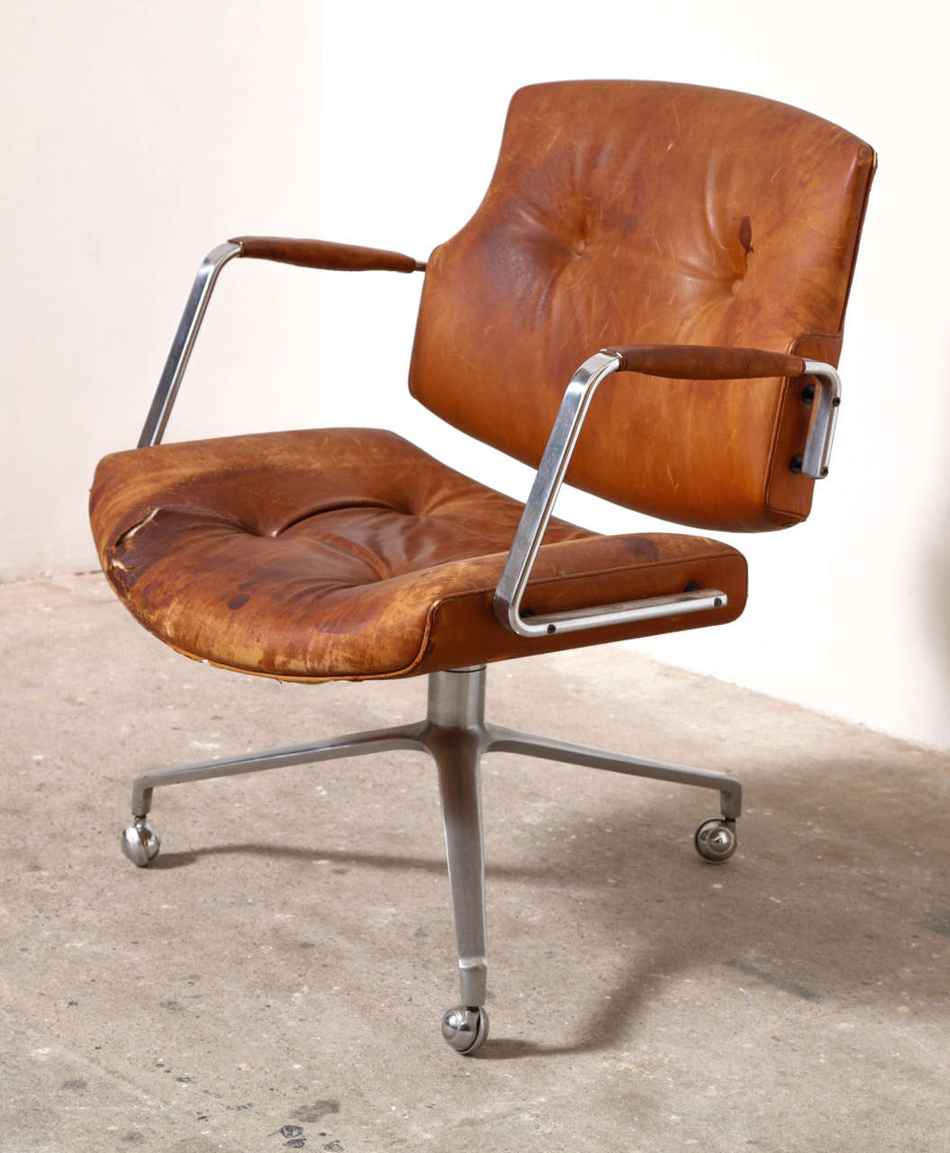 Original lounge or desk chair. Upholstered in cognac leather, with patina, polished chromed steel swivel tripod on castors. Produced by Kill International.