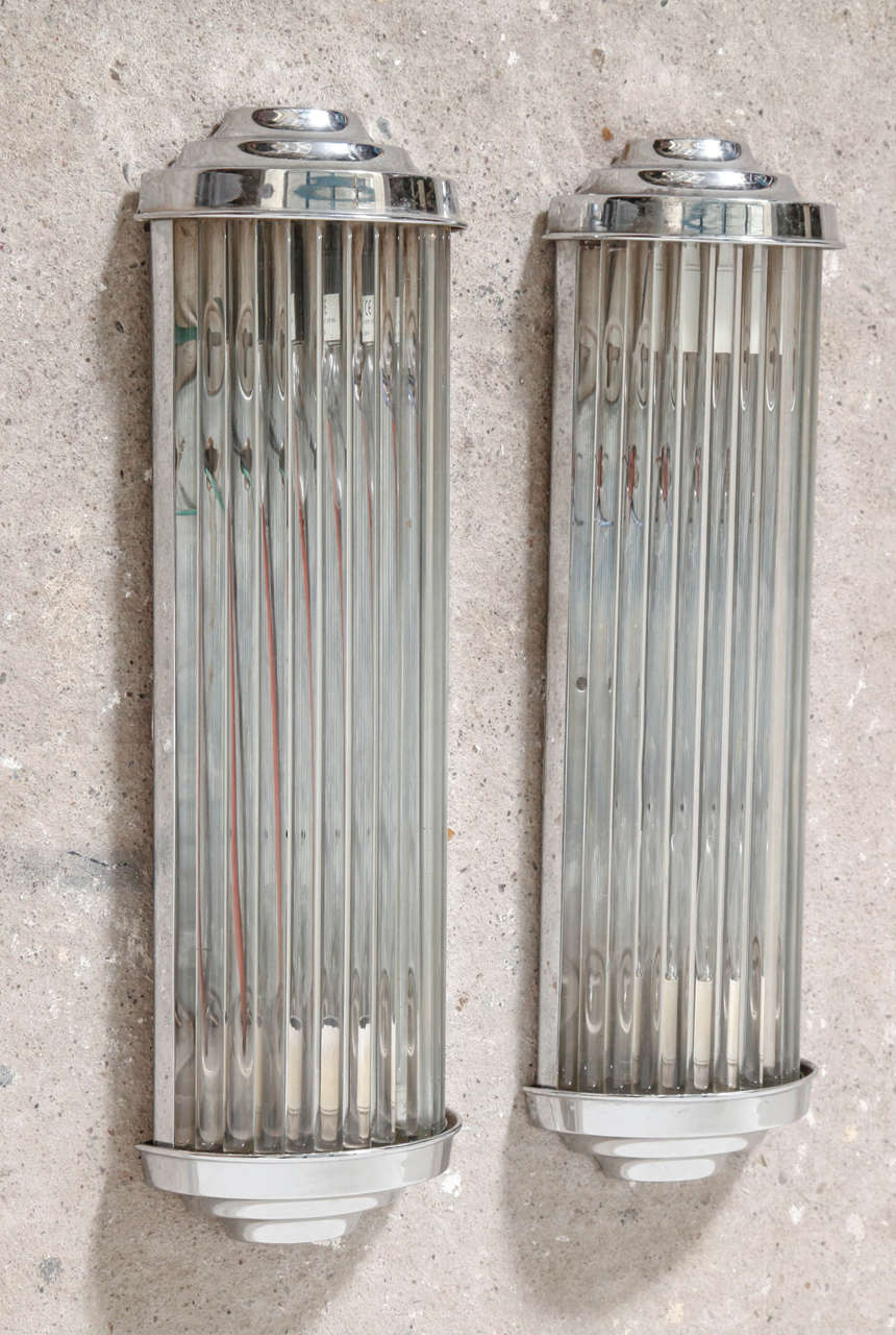 These magnificent Art Deco wall sconces constructed of steel and finished in polish chrome,custom hand cut clear glass rods used to construct the shade.Both fixtures are in unrestored condition but wear their age extremely well and display