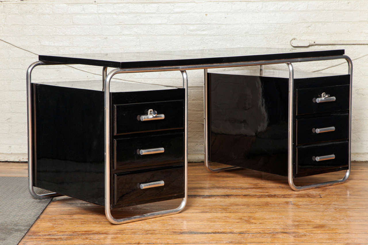 A black lacquered Bauhaus desk with original nickel frame and working lock.