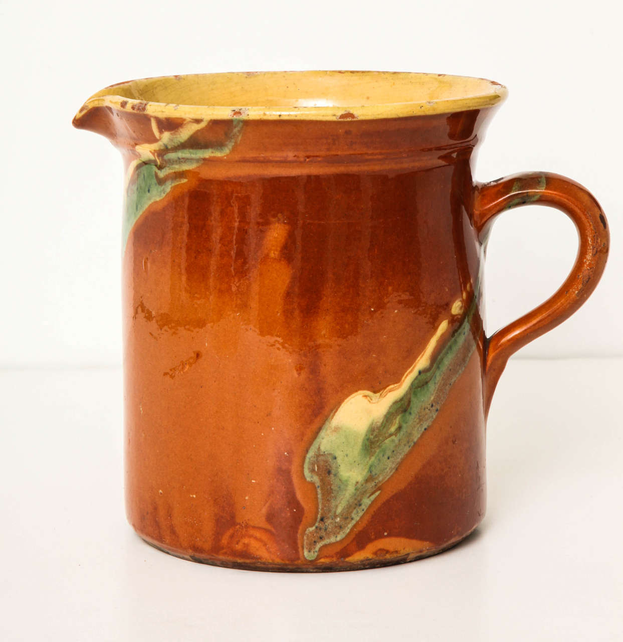 A 19th century French Jaspe pitcher with dripped polychrome decoration